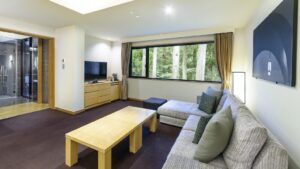 Sofa seating area with table beside large window