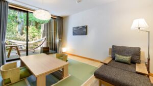 Tatami seating area with sofa, table, and hammock
