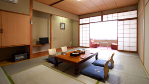 Tatami room with low table, floor cushions, and chairs