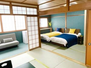 Tatami room with two beds and a sofa