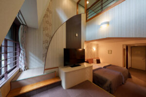 Guest room with bed, loft, and television