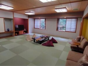Tatami room with low table, floor cushions, and sofa
