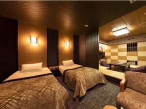 Twin beds beside a raised tatami seating area