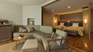 Guest room with sofa seating and two beds