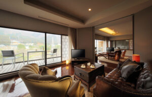 Seating area with armchairs, sofa, and balcony view