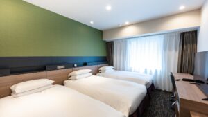 Three beds in a modern guest room