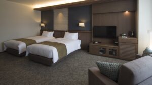 Guest room with twin beds and sofa