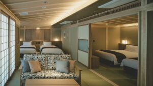 Japanese-style guest room with beds and sofa seating