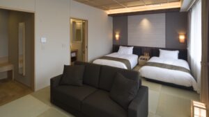 Sofa facing two beds in the guest room