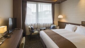 Twin beds beside window seating area