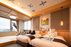 Twin beds in themed guest room with stuffed animals