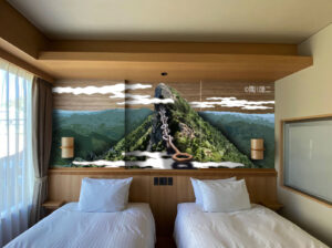 Two twin beds beneath a mural wall