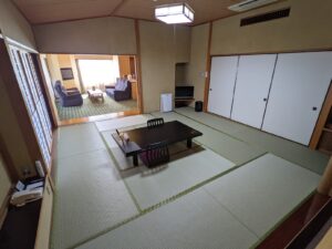 低いテーブルと隣接するくつろぎスペースのある畳の客室