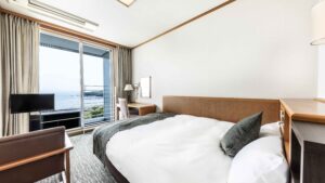 Double bed in guest room beside balcony window