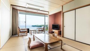Tatami room with low table and ocean-facing chairs