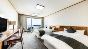 Twin beds in a guest room with ocean view