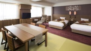 Guest room with two beds, table, and chairs