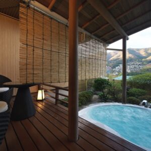 Private open-air bath beside a covered wooden deck