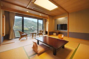 Tatami guest room with low table and balcony chairs