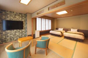 Tatami guest room with twin beds and chairs