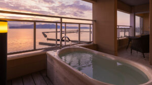 Private bath on balcony overlooking the sea at sunset