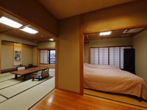 Tatami room beside bedroom with large bed