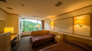 Zwei Einzelbetten in einem Gästezimmer mit Blick aus dem Fenster