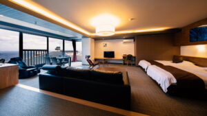 Guest room with twin beds, sofa, and window seating