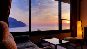 Ocean sunset view through guest room window