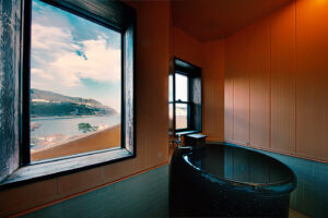 Private bath beside windows overlooking the coast