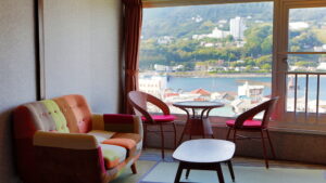 Sofa and table by window overlooking the waterfront