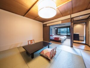 Tatami room with low table and adjacent bedroom