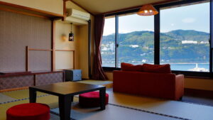 Tatami room with low table, floor cushions, and sofa