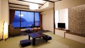 Tatami room with low table, sofa, and ocean window