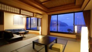 Tatami room with low table, sofa, and ocean windows