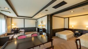 Guest room with two beds and a seating area