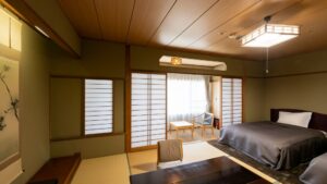 Tatami guest room with bed and window seating area