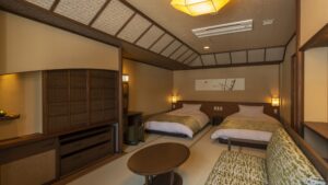 Twin beds and sofa in a tatami guest room