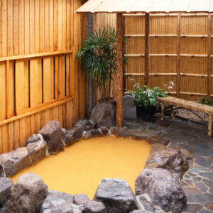 Private outdoor stone bath with bamboo fence