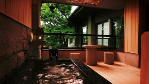 Private open-air bath beside a small seating area