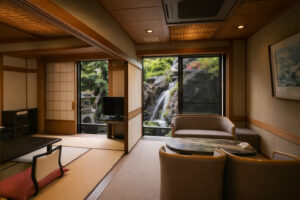 Tatami room with table, chairs, and waterfall view