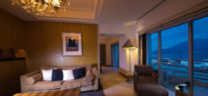 Sofa and chairs beside large windows in guest room