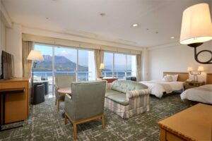 Twin beds and seating area with ocean view