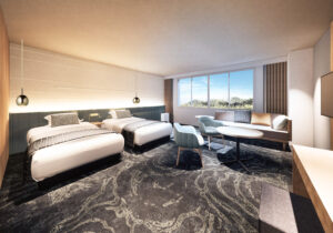 Lits jumeaux et coin salon dans la chambre
