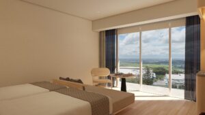 산 전망의 천장부터 바닥까지 이어진 창 옆 트윈 침대