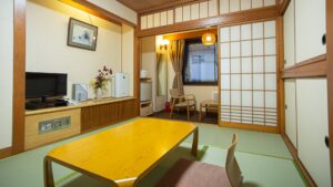 Tatamizimmer mit niedrigem Tisch und Stühlen am Fenster