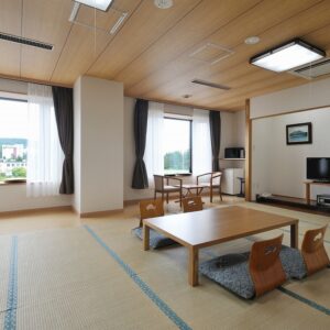 带矮桌、和室椅和窗户的榻榻米客房