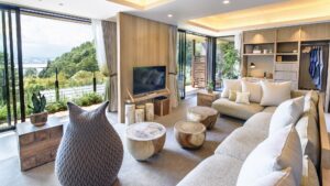 Wohnbereich mit Sofas, Holztischen und großen Fenstern