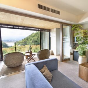 Sitzbereich im Zimmer mit Zugang zum Balkon mit Seeblick