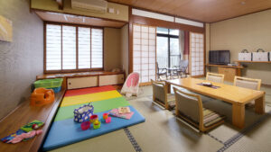 Tatami room with low table, chairs, and play mat